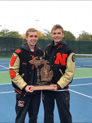 Ilija and a teammate holding the 2018 Michigan Division 1 boys tennis championship trophy